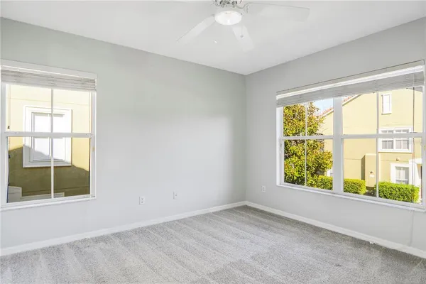 a view of backyard with a chair and potted plants
