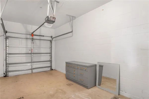 an aerial view of a house with a yard and large trees