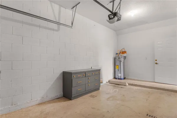 an aerial view of a house with a garden and large trees