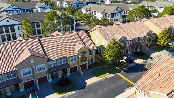 an aerial view of a house with a swimming pool patio and outdoor seating
