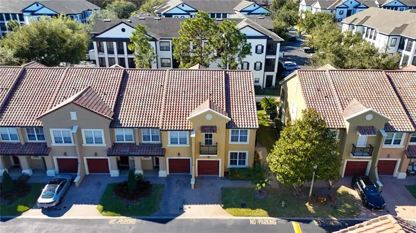 a view of a house with a swimming pool and sitting area