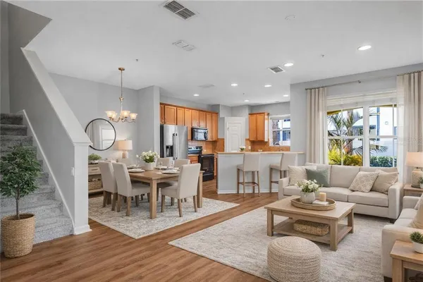 a view of a kitchen with furniture wooden floor and window