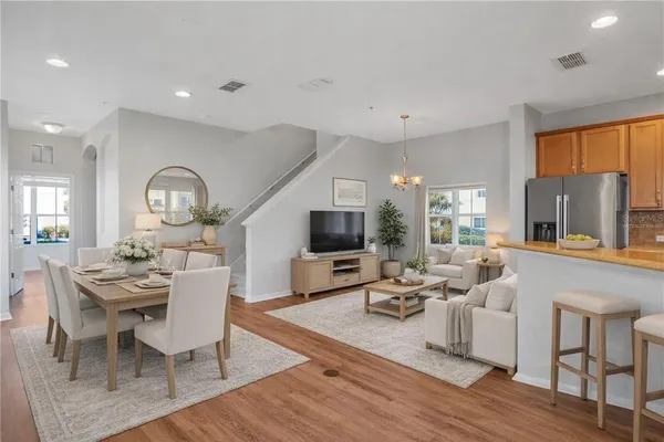 a view of a kitchen with a sink refrigerator and wooden floor