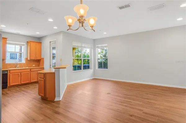 a kitchen with stainless steel appliances granite countertop a refrigerator a stove and a sink