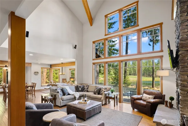 a living room with furniture large windows and a flat screen tv