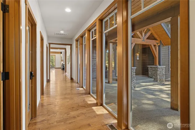 a view of a hallway with wooden walls and door
