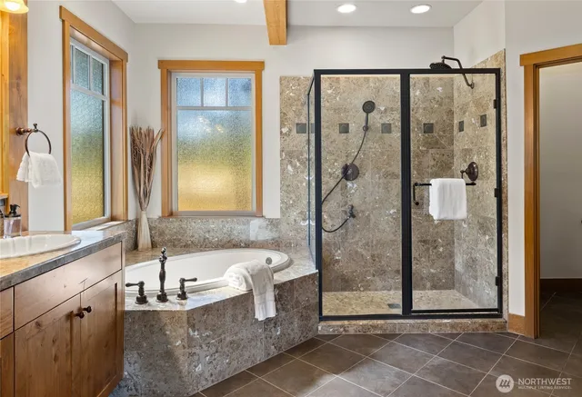 a bathroom with a granite countertop shower a sink and a mirror