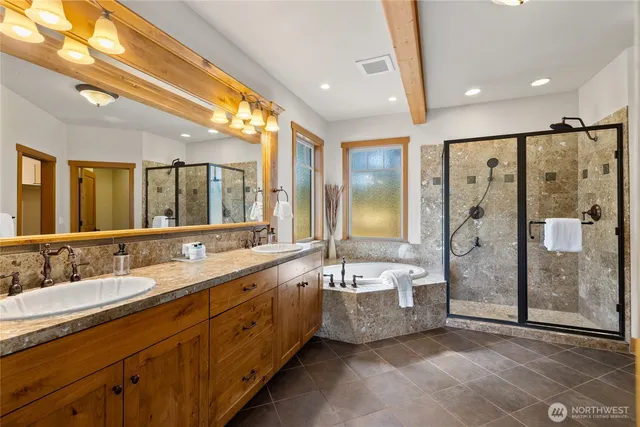 a spacious bathroom with a double vanity sink mirror shower and bathtub