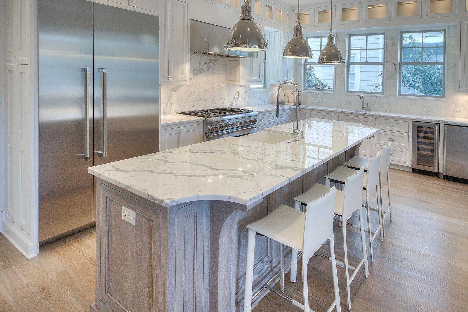 23 Madaket Way Inlet Beach Inlet Beach, FL 32461 - Photo 7 of 49 a kitchen with stainless steel appliances kitchen island a table chairs in it and wooden floors