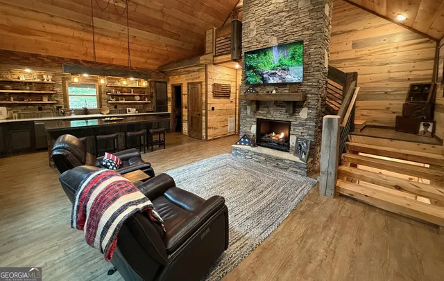 a living room with furniture a flat screen tv and a fireplace