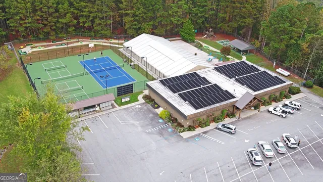 an outdoor view of house with swimming pool and green space