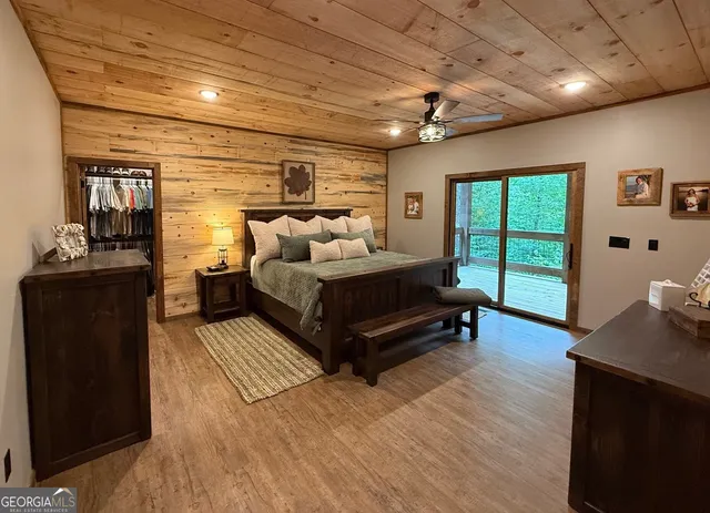 a spacious bedroom with a bed and a dresser