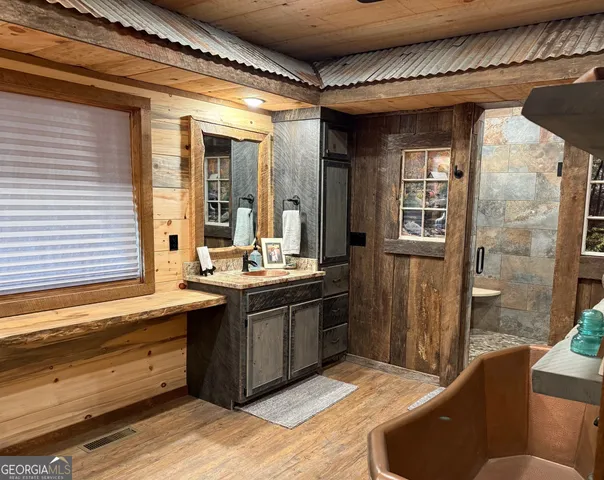 a room with stainless steel appliances a sink and a wooden cabinets