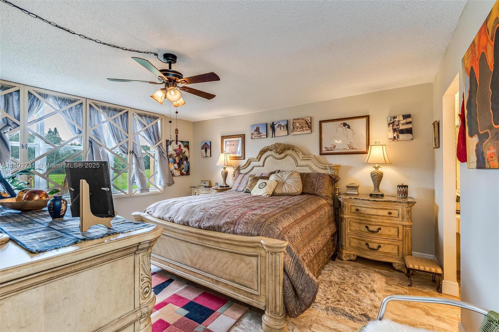 3671 Environ Boulevard, Unit 169 Lauderhill, FL 33319 - Photo 11 of 23 a bedroom with a bed and a chandelier