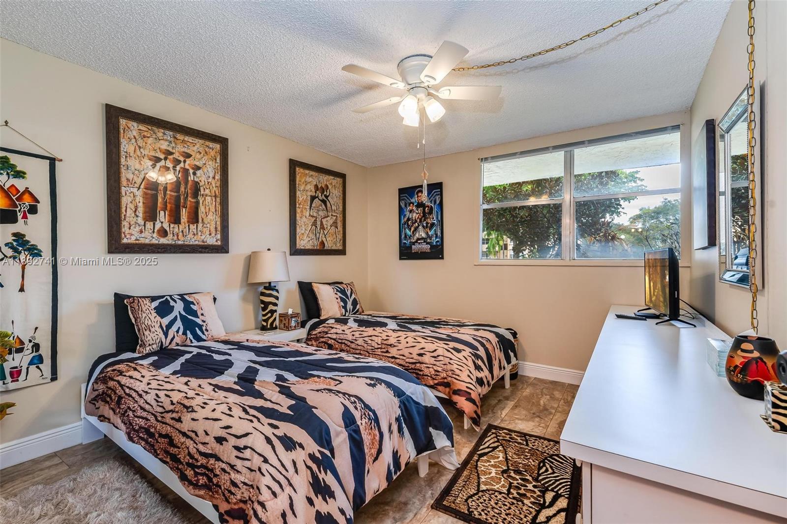 3671 Environ Boulevard, Unit 169 Lauderhill, FL 33319 - Photo 14 of 23 a bedroom with a large bed and a large window
