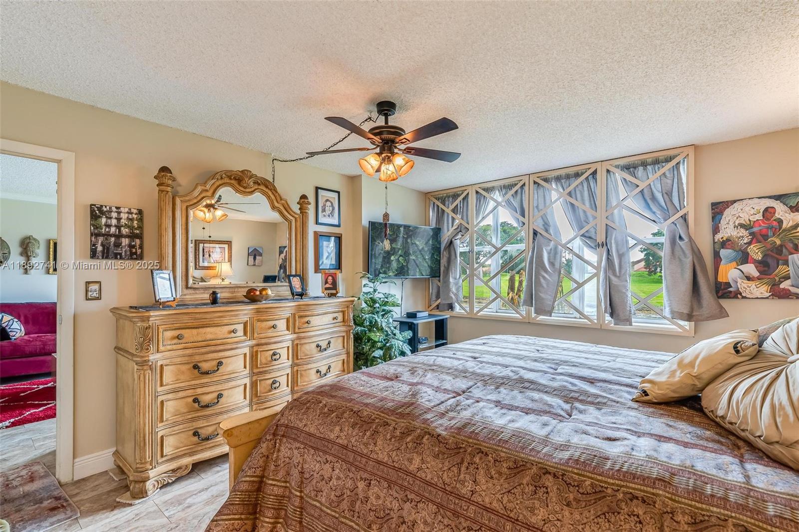 3671 Environ Boulevard, Unit 169 Lauderhill, FL 33319 - Photo 16 of 23 a bedroom with a bed and a dresser in it