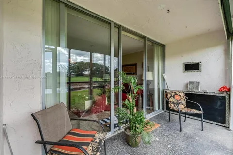 a living room with hardwood floor and a floor to ceiling window
