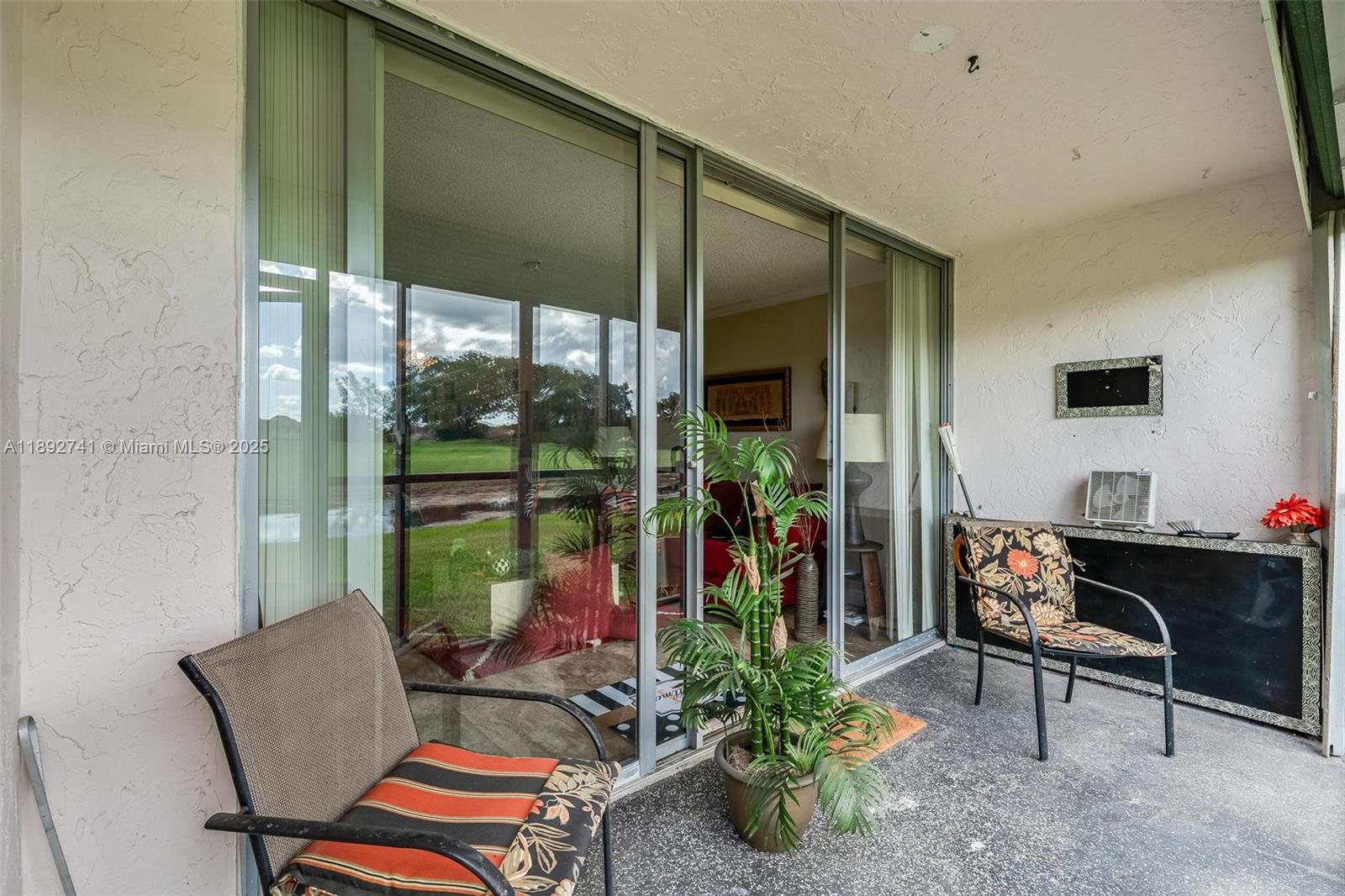 3671 Environ Boulevard, Unit 169 Lauderhill, FL 33319 - Photo 17 of 23 a living room with furniture and a potted plant