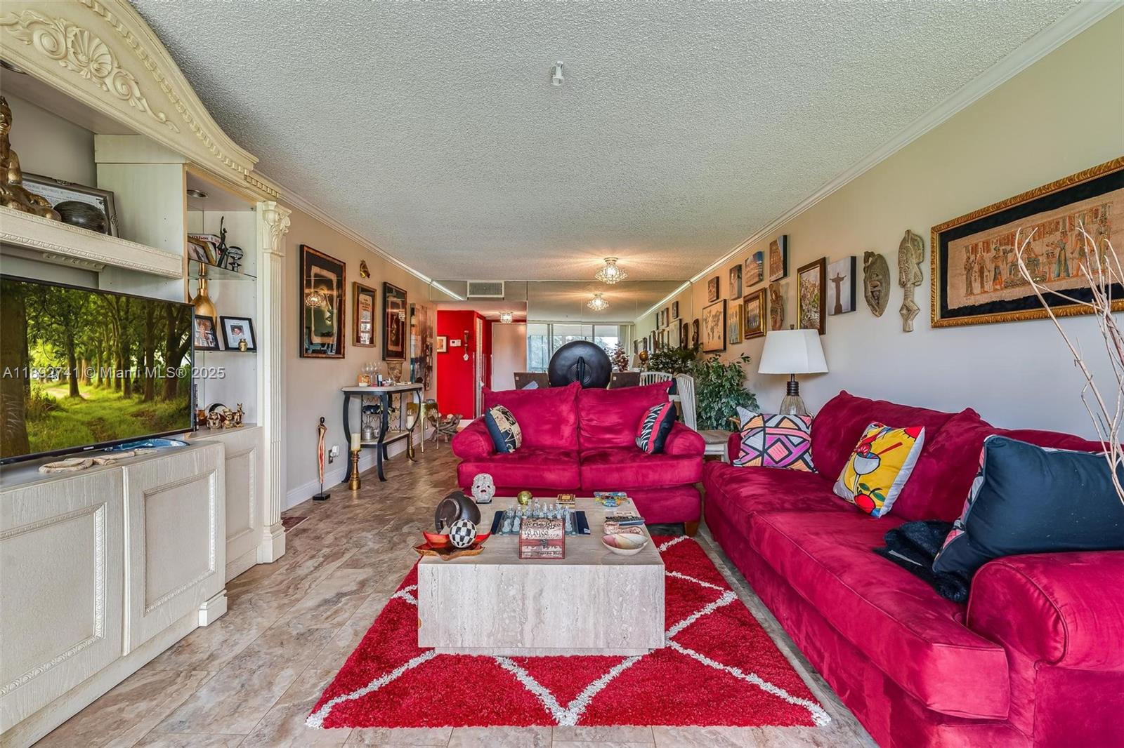 3671 Environ Boulevard, Unit 169 Lauderhill, FL 33319 - Photo 7 of 23 a living room with furniture and a flat screen tv