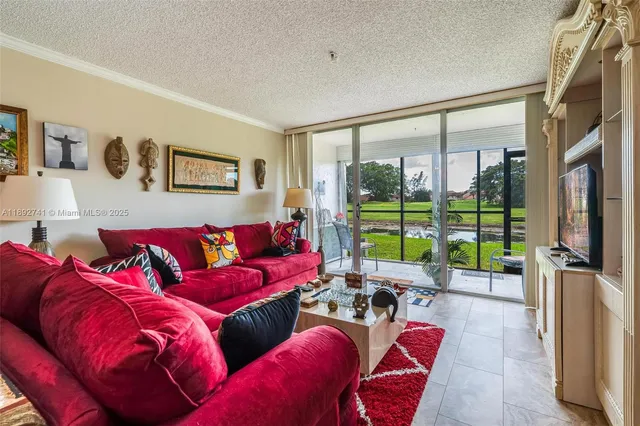a living room with furniture and a floor to ceiling window