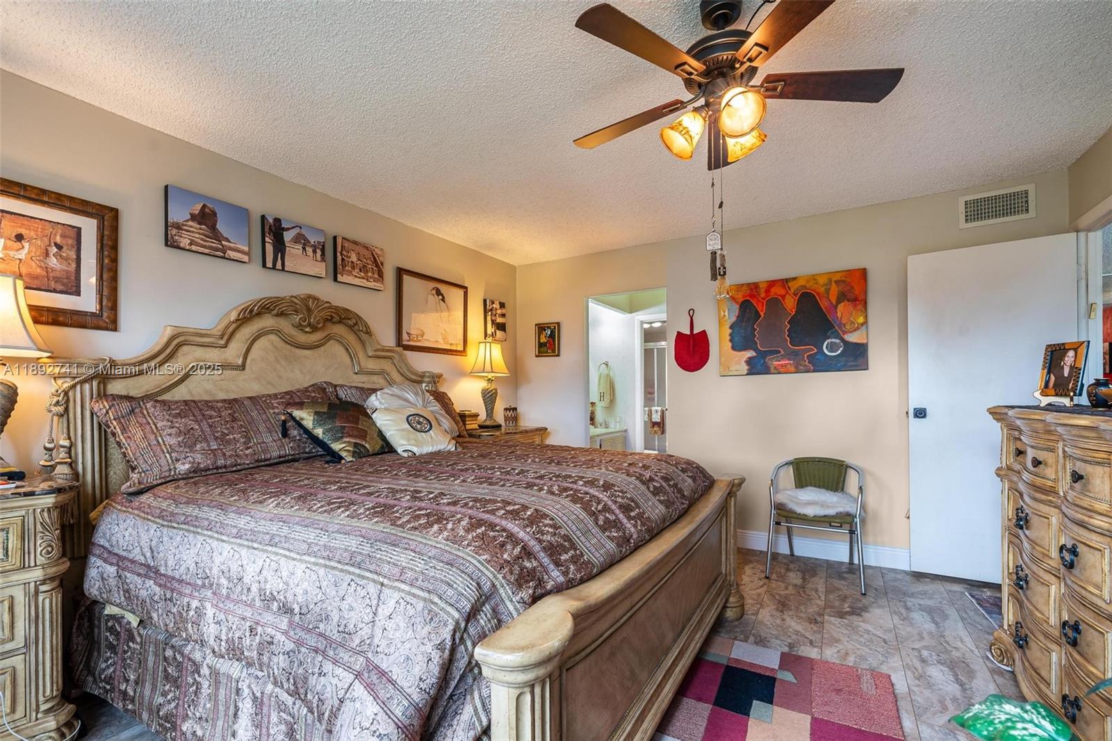 3671 Environ Boulevard, Unit 169 Lauderhill, FL 33319 - Photo 10 of 23 a bedroom with a bed and a chandelier