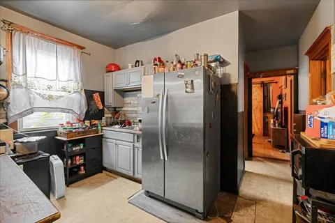 a kitchen with stainless steel appliances granite countertop a refrigerator and a stove