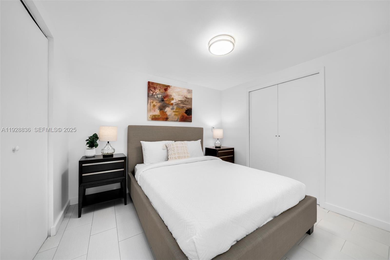 485 Brickell Avenue, Unit 1709 Miami, FL 33131 - Photo 13 of 22 a bedroom with a bed and a chandelier