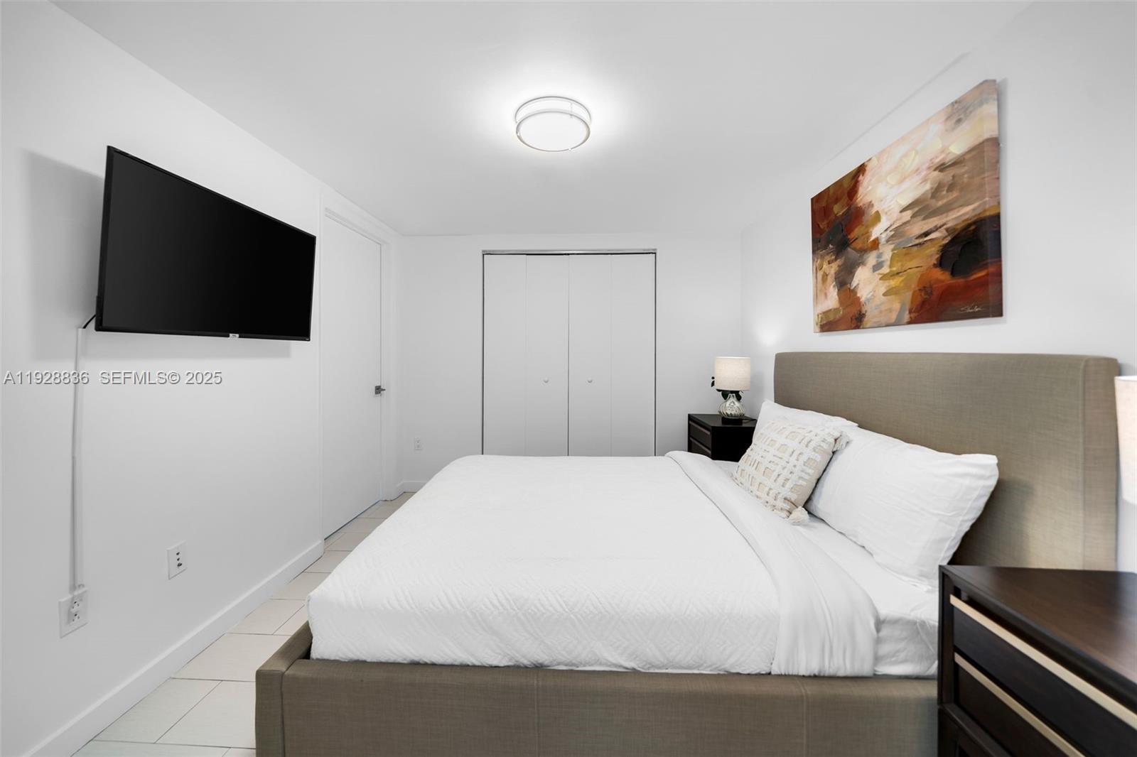 485 Brickell Avenue, Unit 1709 Miami, FL 33131 - Photo 14 of 22 a bedroom with a bed and a flat screen tv