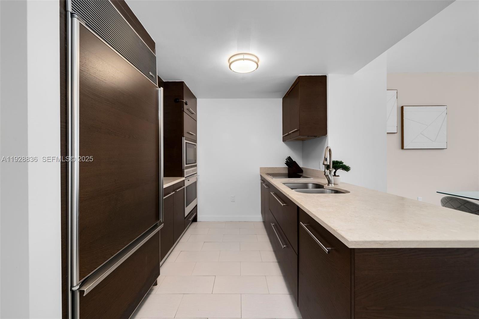 485 Brickell Avenue, Unit 1709 Miami, FL 33131 - Photo 15 of 22 a kitchen with a sink and a refrigerator