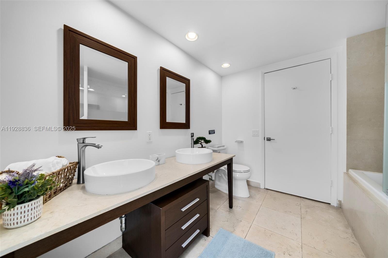 485 Brickell Avenue, Unit 1709 Miami, FL 33131 - Photo 16 of 22 a bathroom with a sink and a mirror