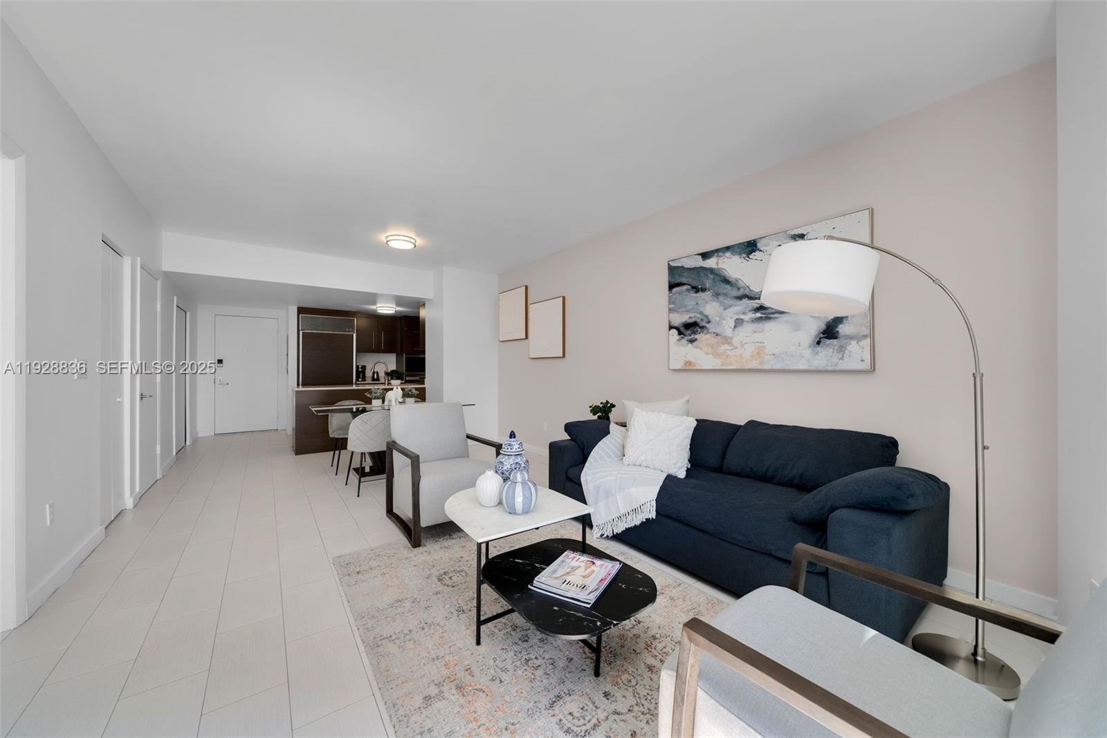 485 Brickell Avenue, Unit 1709 Miami, FL 33131 - Photo 4 of 22 a living room with furniture and a flat screen tv