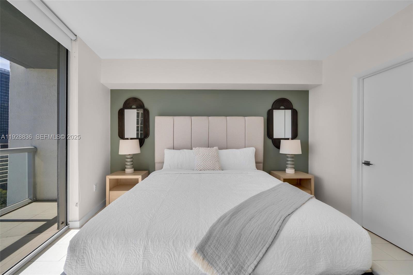 485 Brickell Avenue, Unit 1709 Miami, FL 33131 - Photo 9 of 22 a bedroom with a bed and a mirror