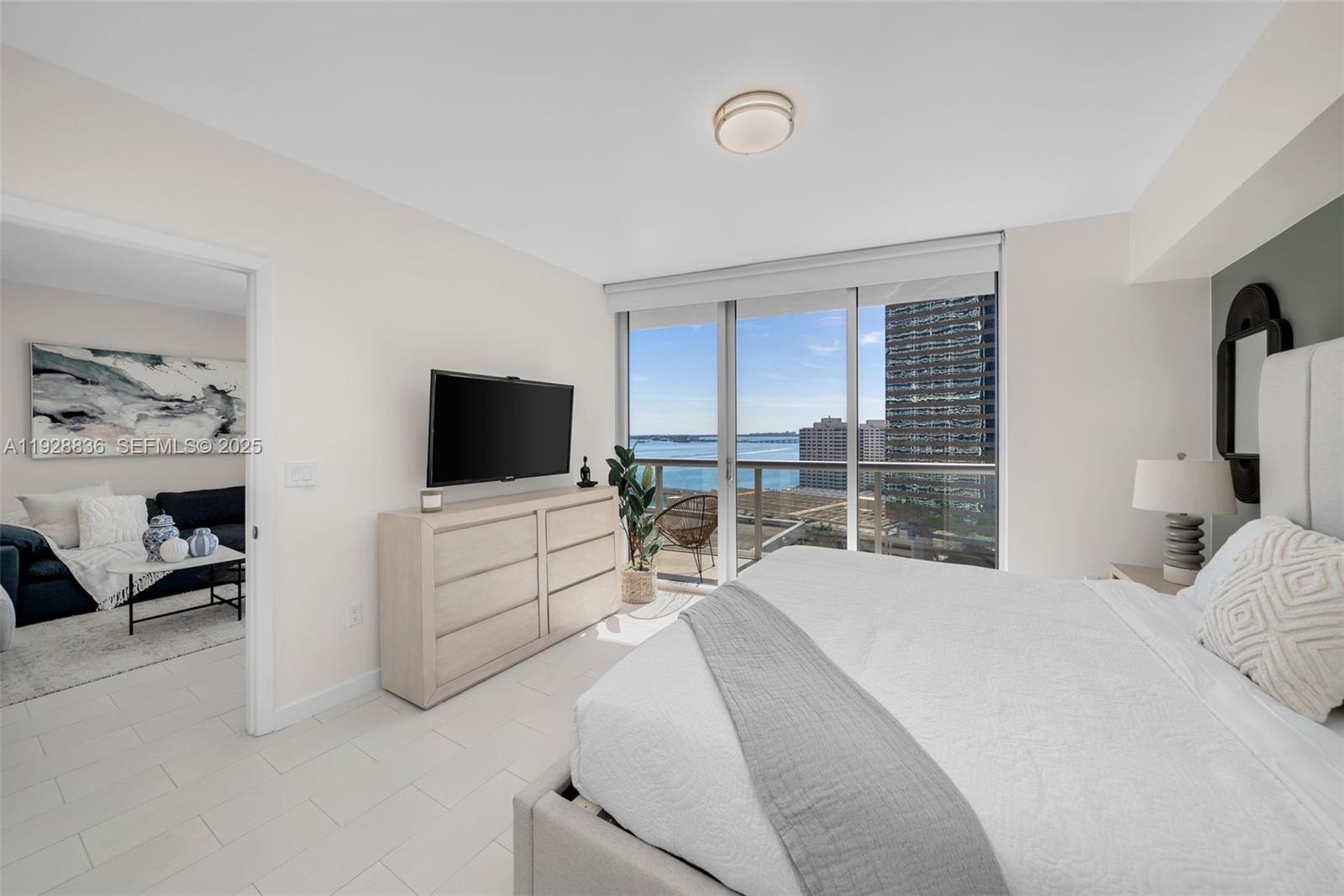 485 Brickell Avenue, Unit 1709 Miami, FL 33131 - Photo 10 of 22 a bedroom with furniture and a flat screen tv