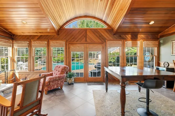 a living room with furniture a floor to ceiling window and floor to ceiling window
