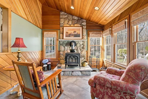a living room with fireplace furniture and a rug