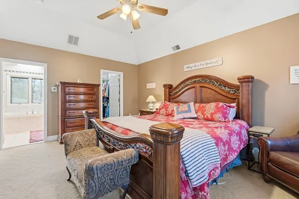 a spacious bathroom with a granite countertop sink mirror and bathtub