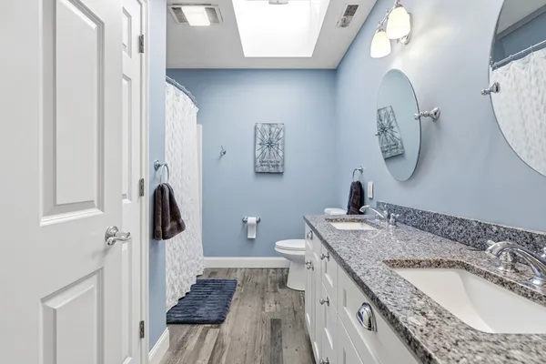 a bedroom with bed tv and window