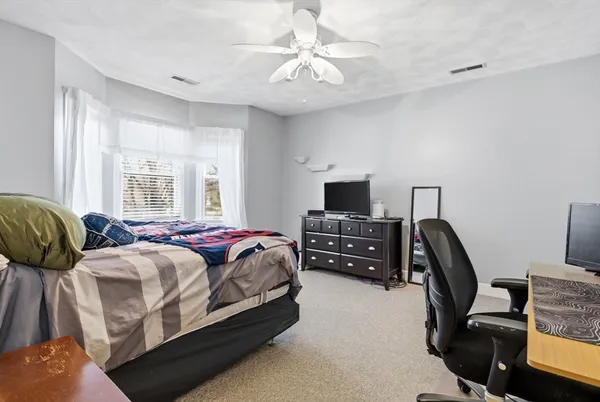 a living room with stainless steel appliances furniture and wooden floor