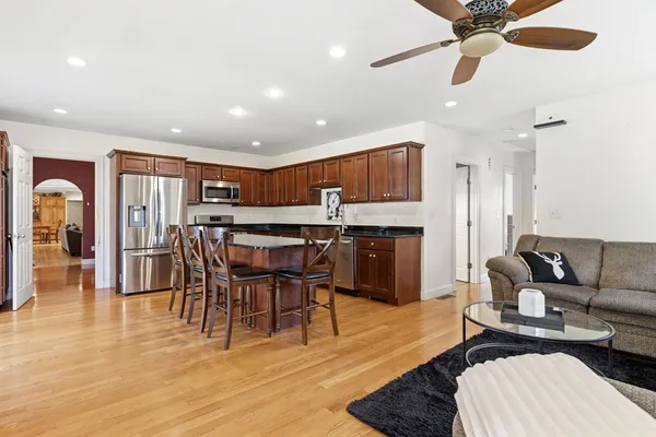 a living room with furniture and a wooden floor