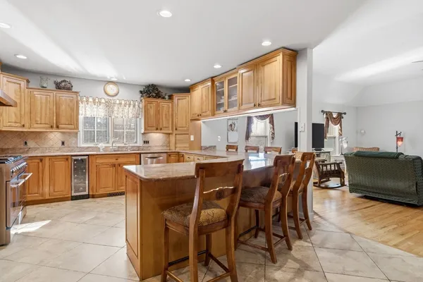 a kitchen with stainless steel appliances granite countertop a stove sink and cabinets