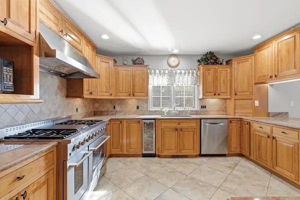 a kitchen with stainless steel appliances granite countertop a stove top oven microwave and cabinets