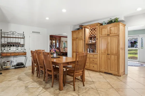 a dining room filled with furniture and wooden floor