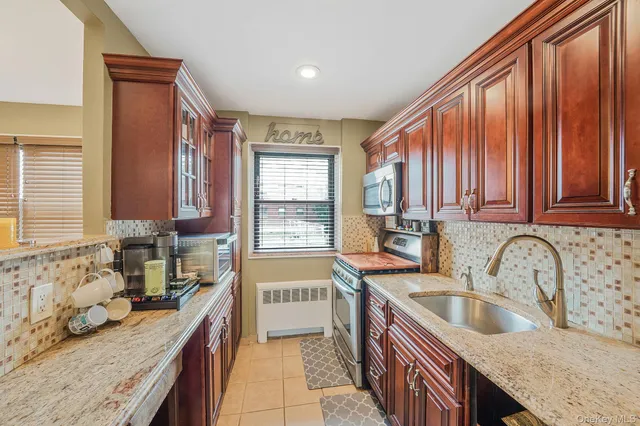 a kitchen with a sink stove top oven and cabinets