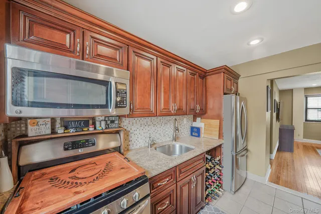 a kitchen with stainless steel appliances granite countertop a sink and a cabinets