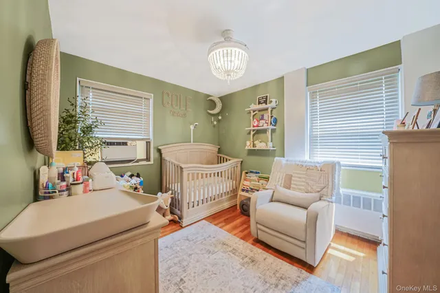 a bedroom with furniture and a large window