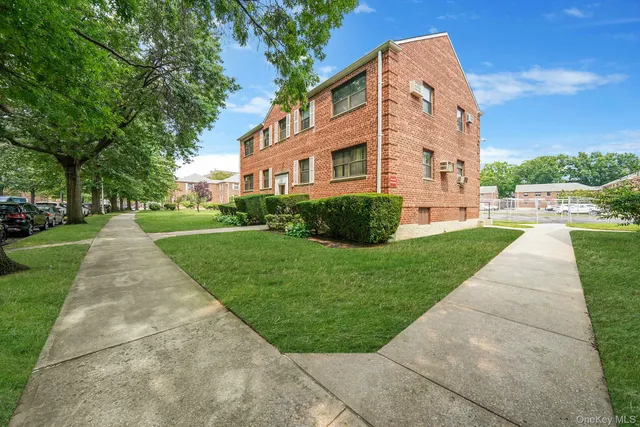 a front view of a building with a yard