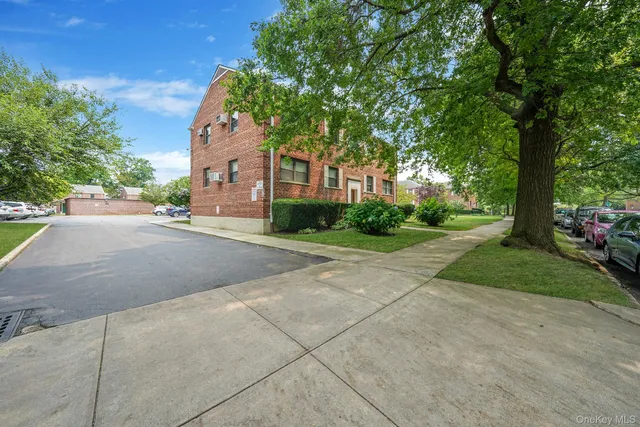 a pathway of a house with a yard