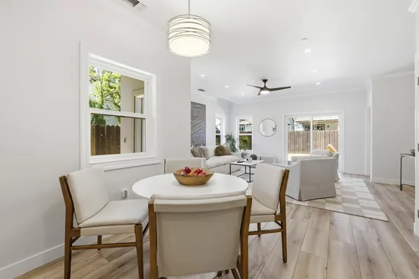 a view of a dining room with furniture window and wooden floor