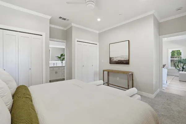 a bedroom with a bed and a painting on the wall