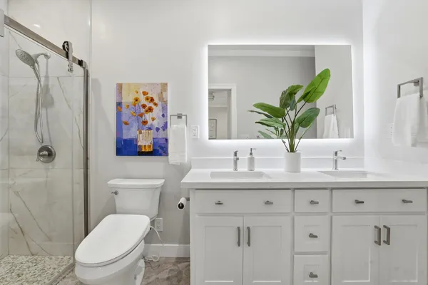 a bathroom with a toilet sink and mirror